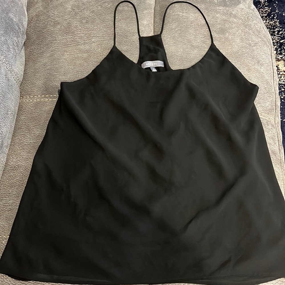 Women’s strap blouse size Medium black 100% polyester. Classy thin straps.